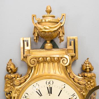 A wall clock in gustavian style, marked Rob. Engström, Stockholm.