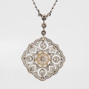 A platinum pendant set with a bouton pearl and old- and rose-cut diamonds.