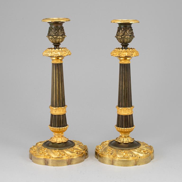 A pair of ormolu late empire candlesticks, mid 19th century.