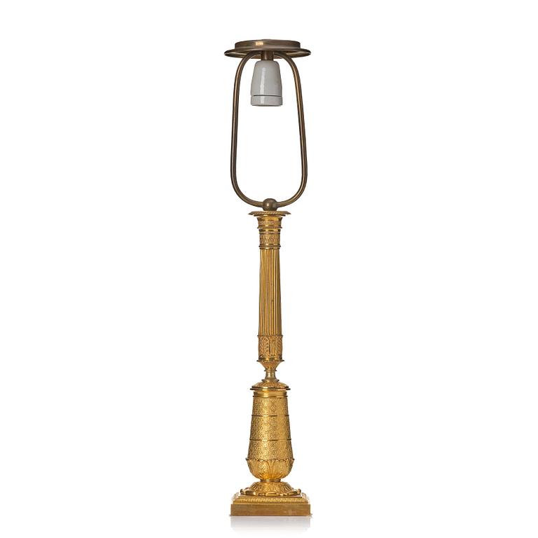 An gilded Empire table lamp.