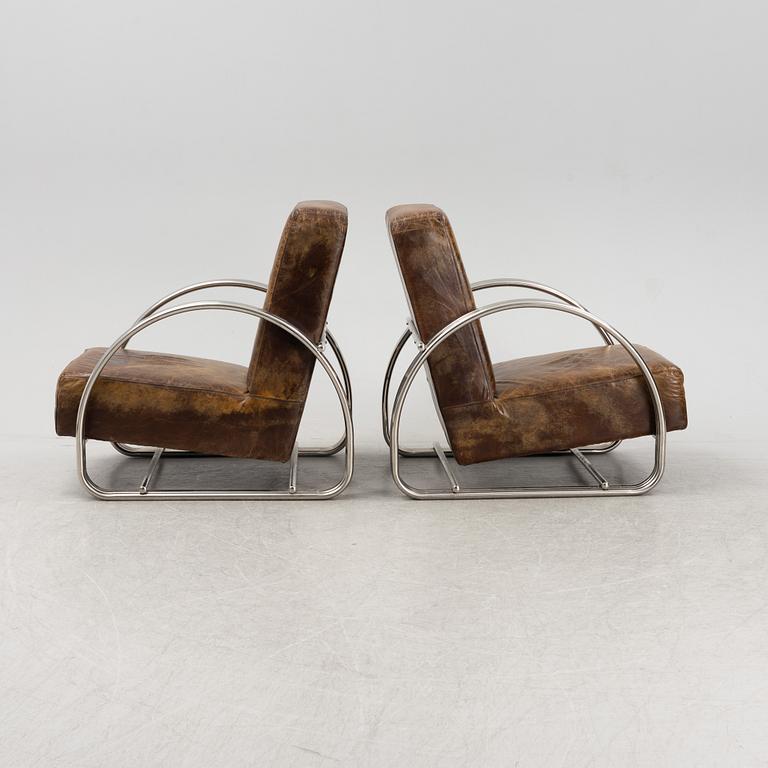 A pair of 'Hudson Street' lounge chairs from Ralph Lauren home.