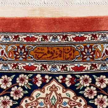 An Oktagonal  silk Qum rug, Central Persia, signed, c. 250 x 250 cm.