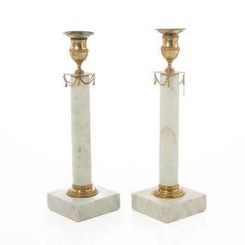 A pair of late Gustavian gilt brass and marble candlesticks, circa 1800.