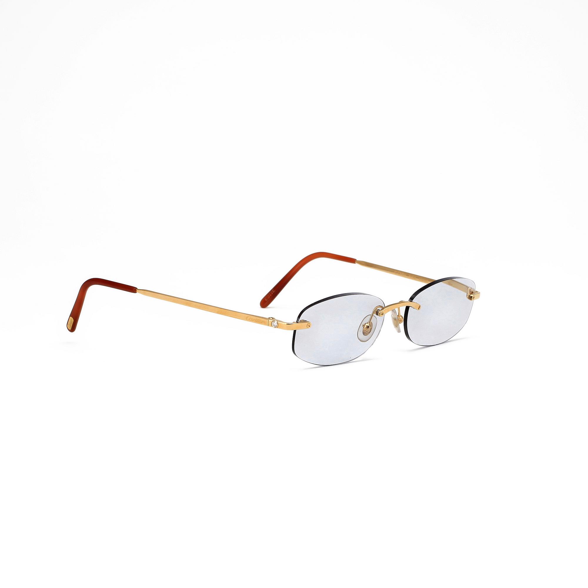 GLASSES, CARTIER, gold plated, titanium sset with two brilliant cut diamonds, tot. 0.10 cts. Paris.