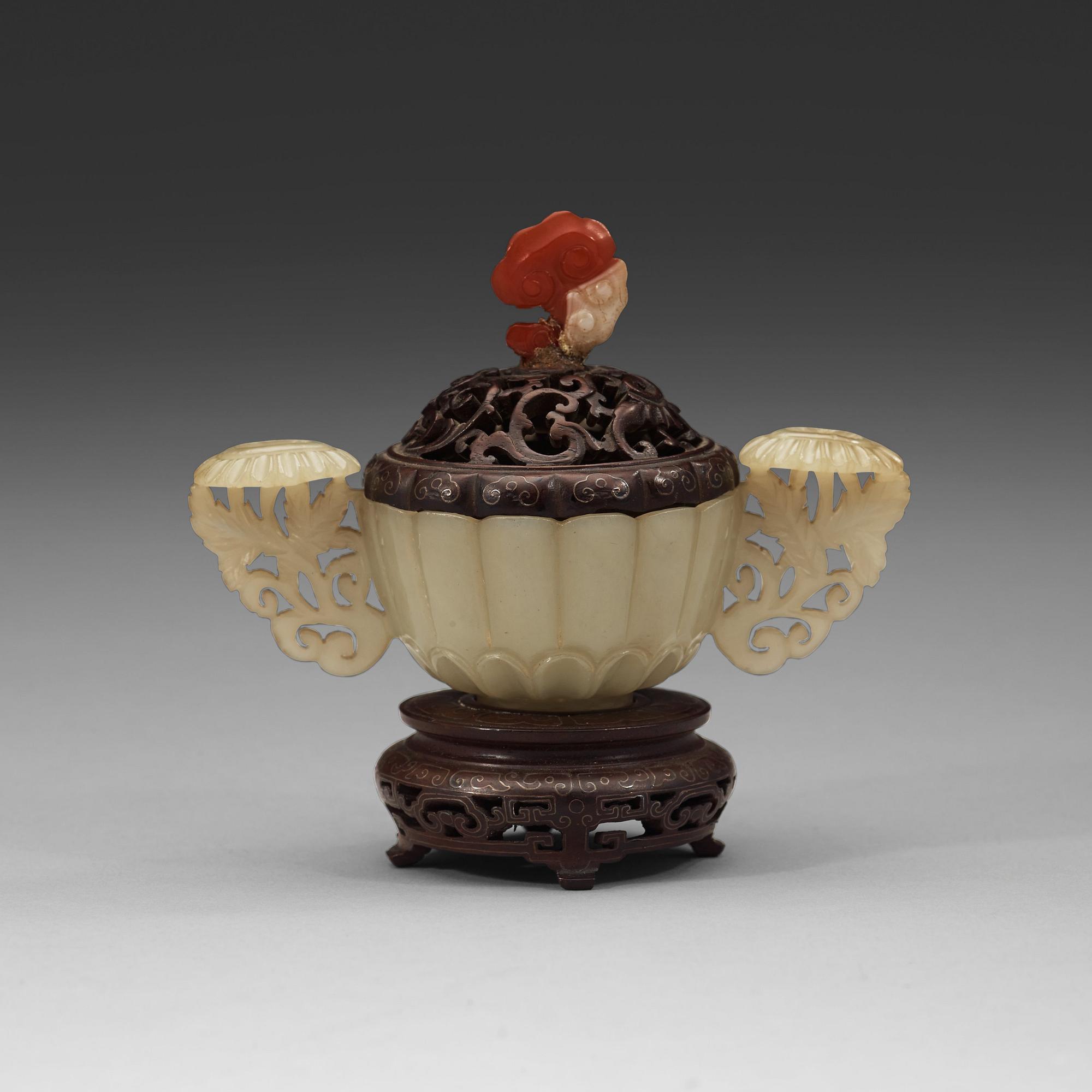 A nephrite cup with wooden cover and stand with silver inlay and quartz finial, Qing dynasty, 19th Century.