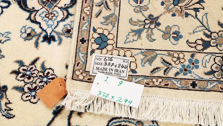 A Nain, part silk carpet, c. 337 x 244 cm.