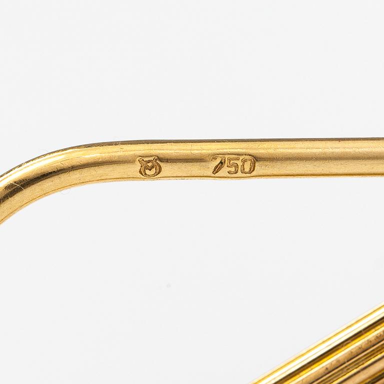 A keychain made of 18K gold with a 900 gold Helvetia 20 franc coin.