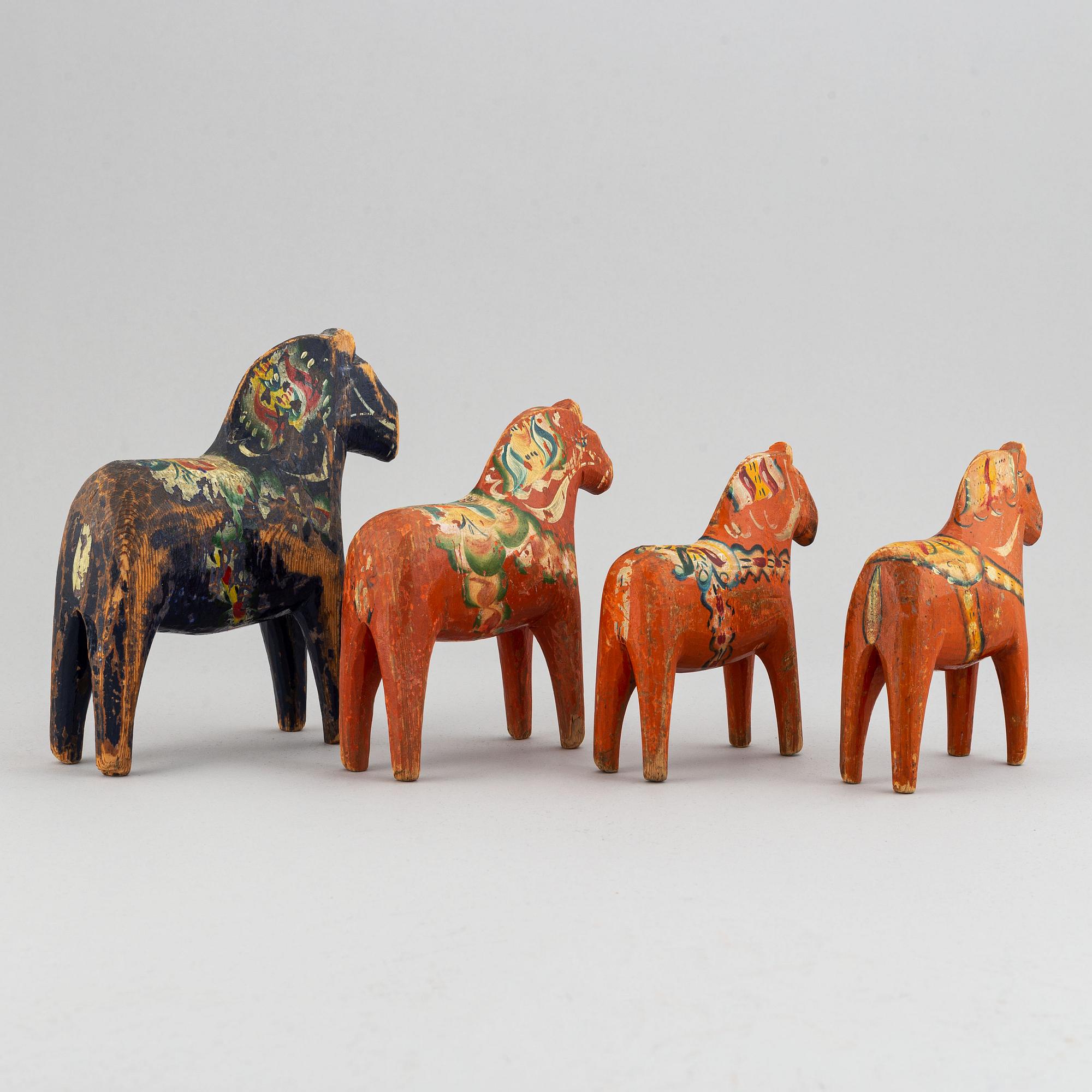 A set of 4 painted wooden horses from the first half of the 20th century.