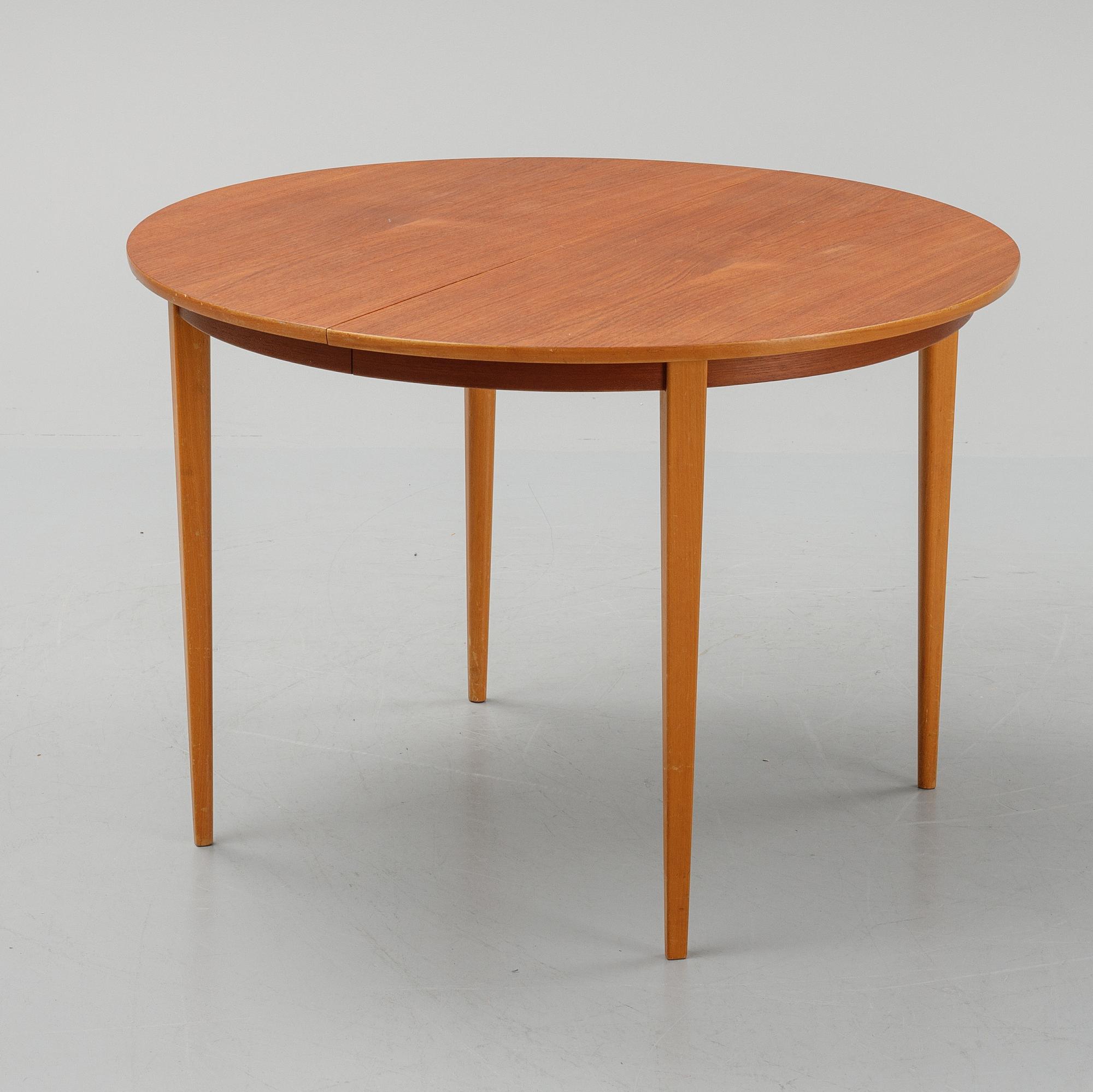 A teak dining table with 4 'Monaco' chairs, mid 20th century.