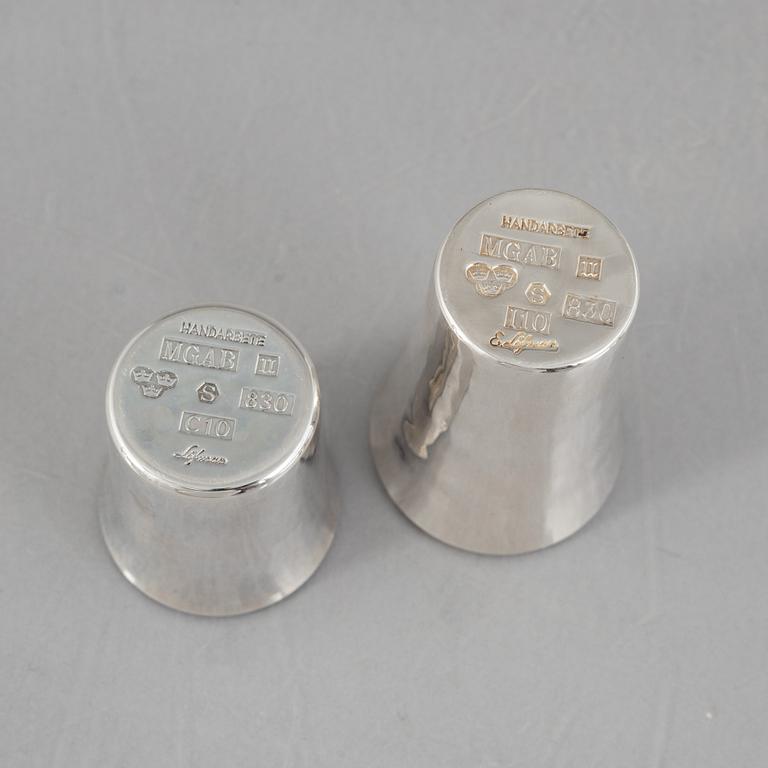 Eric Löfman, a Swedish silver candlestick, a vase and four cups, including MGAB, Uppsala 1977.