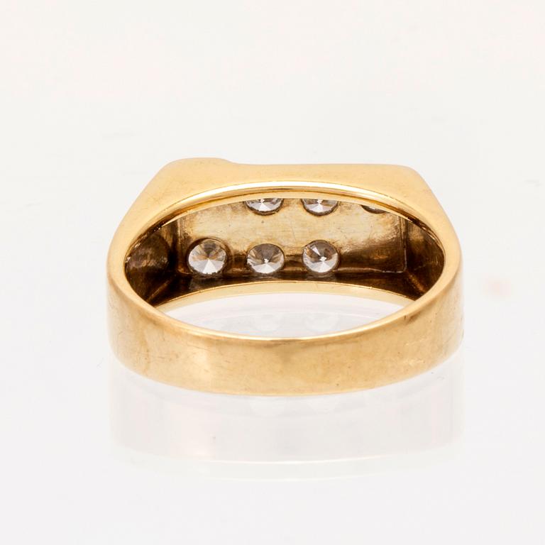 An 18K gold ring set with round brilliant cut diamonds.