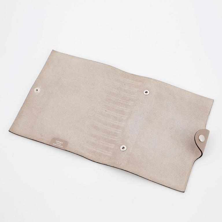HERMÈS, a taupe veau togo leather notebook, "Ulysse Petit Modèle".