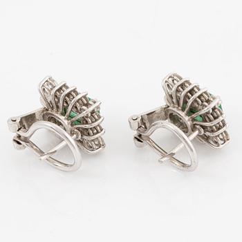 Earrings set with emerald-cut emeralds and brilliant-cut diamonds.