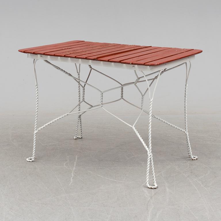 A garden table and four chairs, first half 20th century.