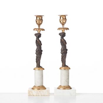 A pair of late Gustavian circa 1800 white marble and bronze candlesticks.