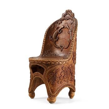 263. Knut Fjaestad, an Art Nouveau folk art sculptured pine chair, Sweden early 1900's.