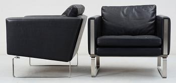 A pair of Hans J Wegner steel and black leather 'CH-101' easy chairs, Carl Hansen & Son, Denmark.