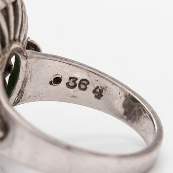A palladium-plated silver ring with cabochon-cut jadeite and diamonds.