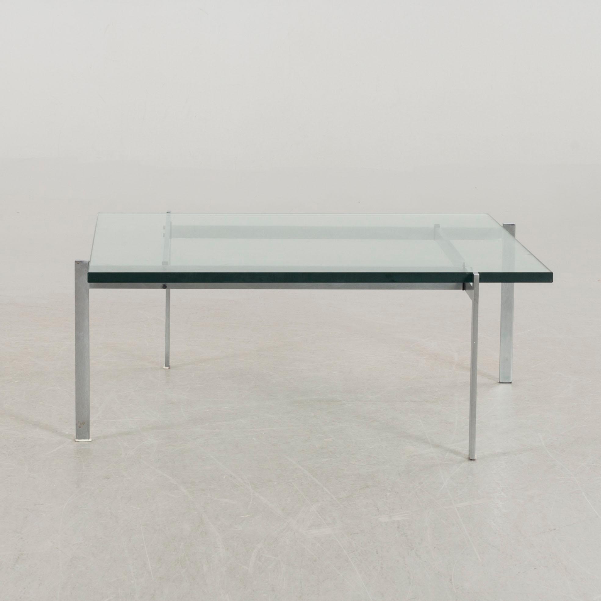 A Poul Kjaerholm PK61 glass table by Fritz Hansen.