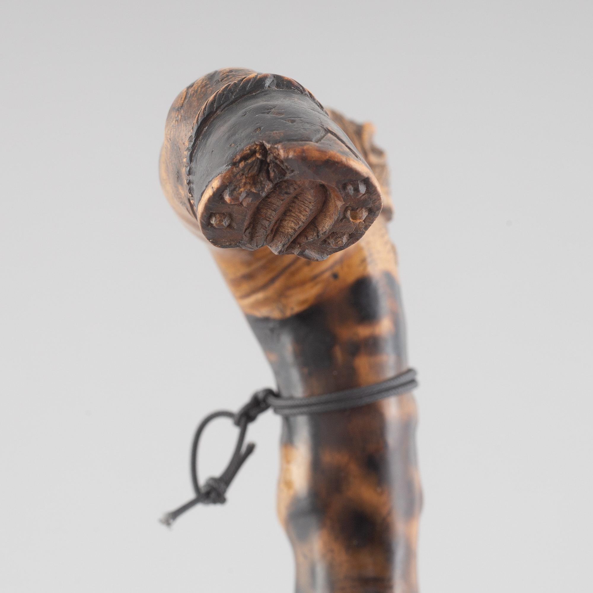 A carved wooden cane, 19th century.
