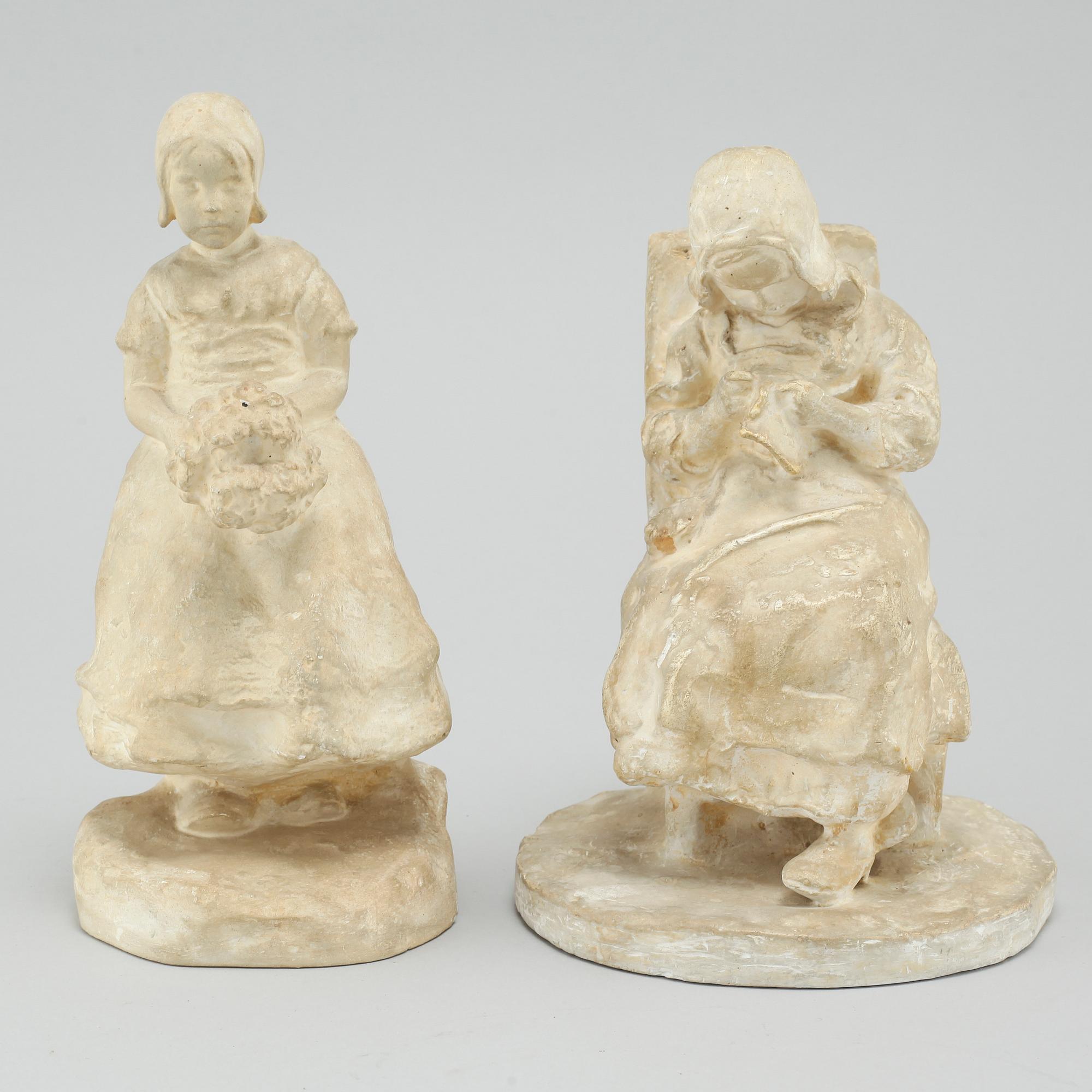 two plaster figurines, signed.