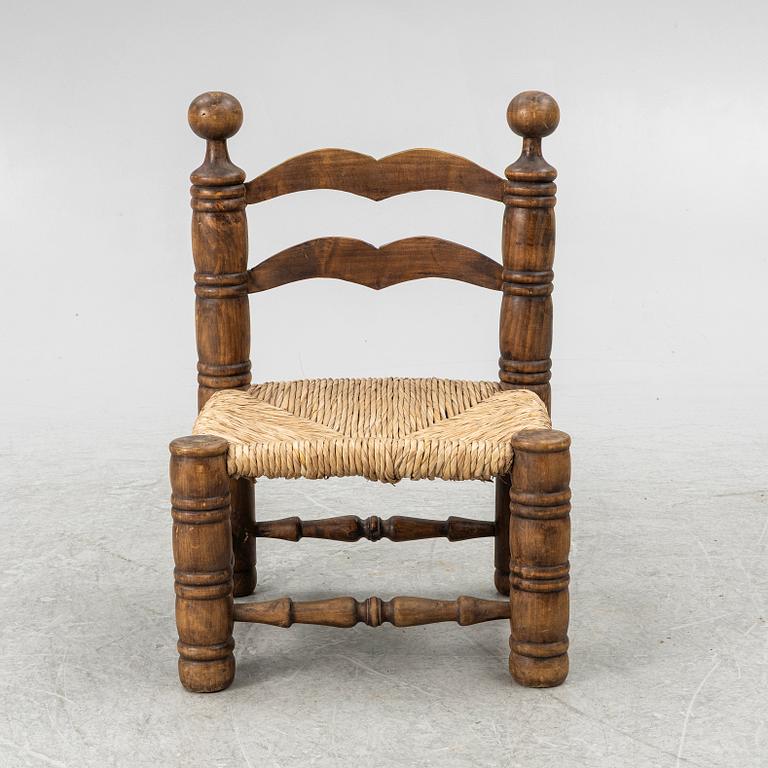 Charles Dudouyt, attributed to, a fireside low chair, mid 20th century.