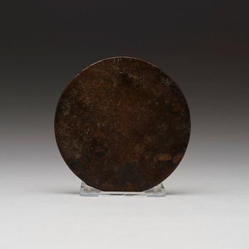 A bronze mirror, presumably Ming dynasty (1368-1643).