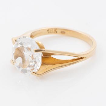 Ring, 18K gold with a synthetic white stone.