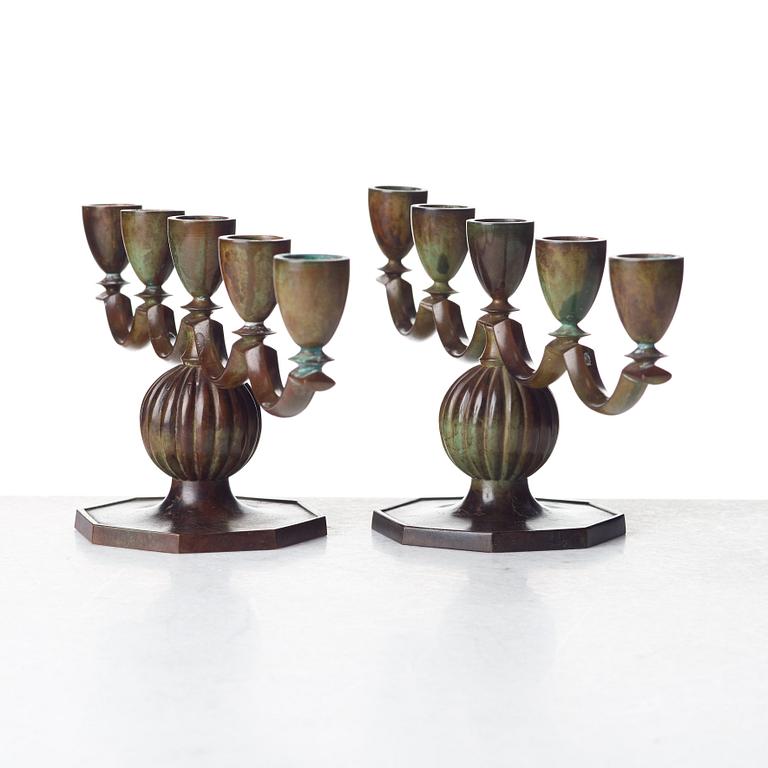 GULDSMEDSAKTIEBOLAGET (GAB), a pair of Swedish Grace patinated bronze candelabra, Stockholm 1930's.