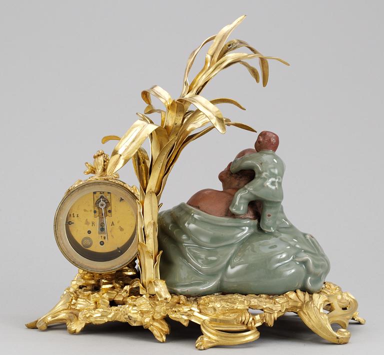 A French Louis XV-style late 19th century table clock.