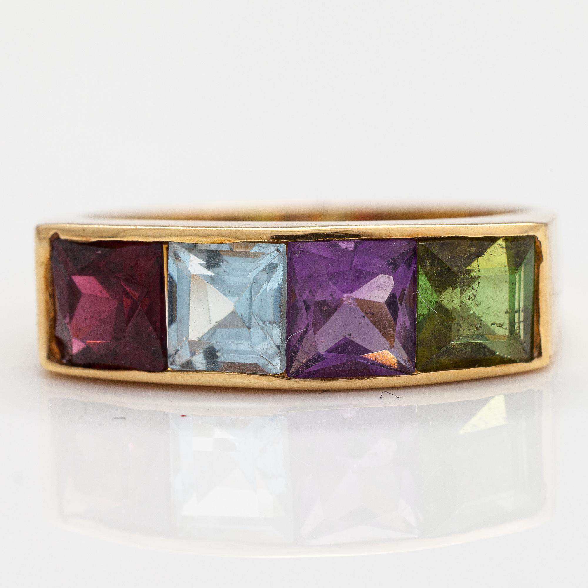 An 18K gold ring with an amethyst, garnet, topaz and peridote.