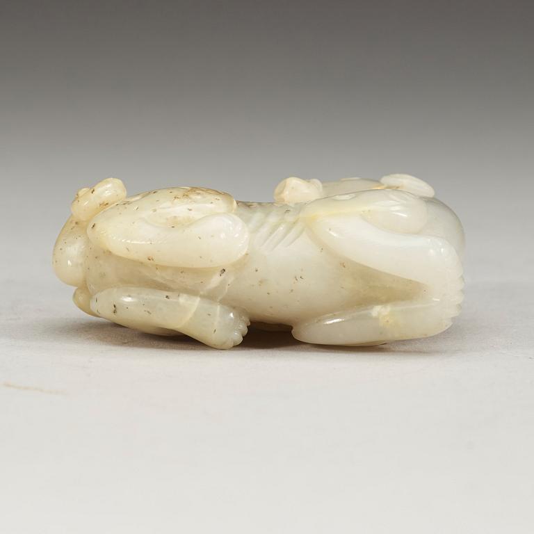 A carved nephrite figure of a reclining dragon carrying lingzhi fungus in his mouth, Qing dynasty (1644-1912).