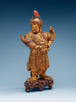 1273. A lacquered and gilt wooden figure of a warrior, Qing dynasty, ca 1800.