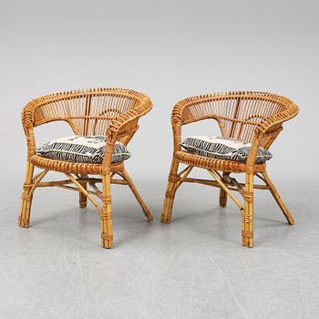 A pair of rattan chairs.