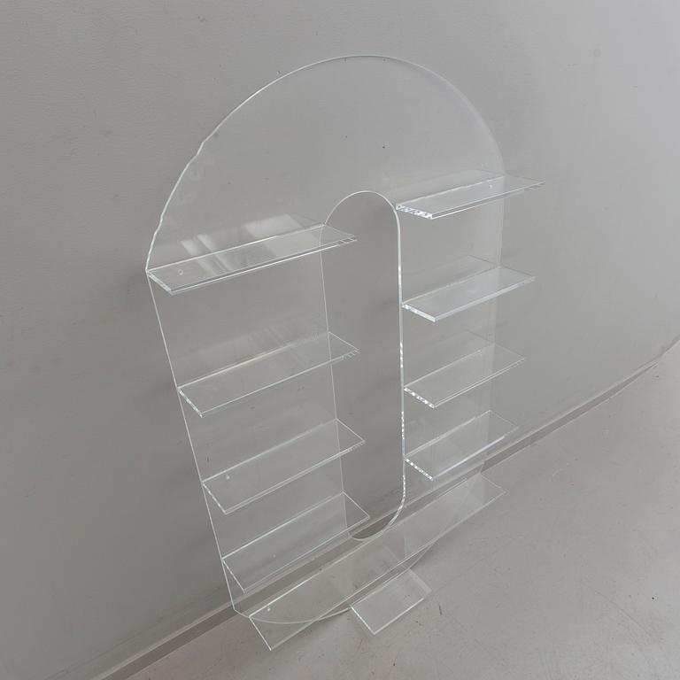 Shelf, plexi glass, in the shape of the letter 'O',Non Violence.