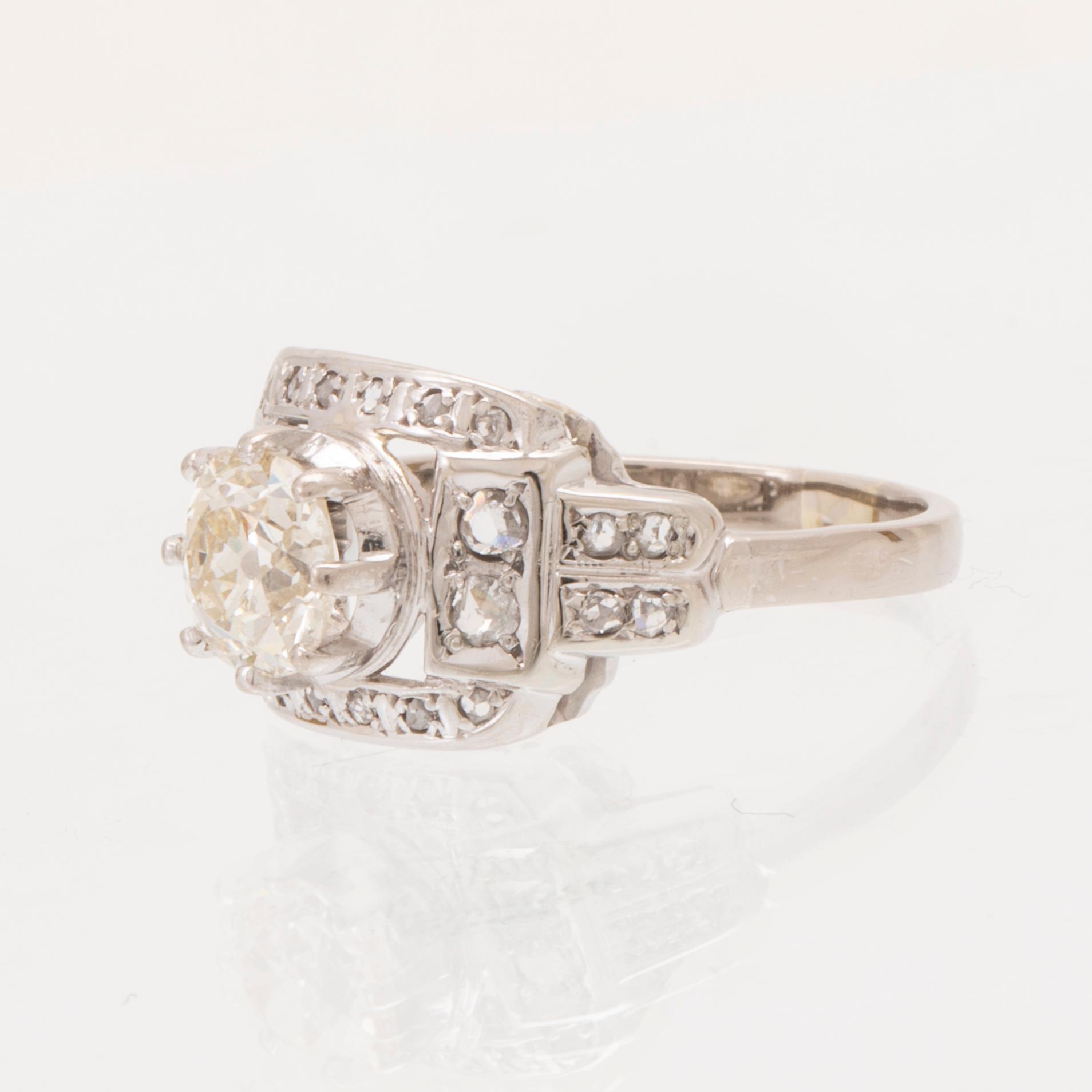 An 18K white gold ring set with an old cut diamond and rose cut diamonds.