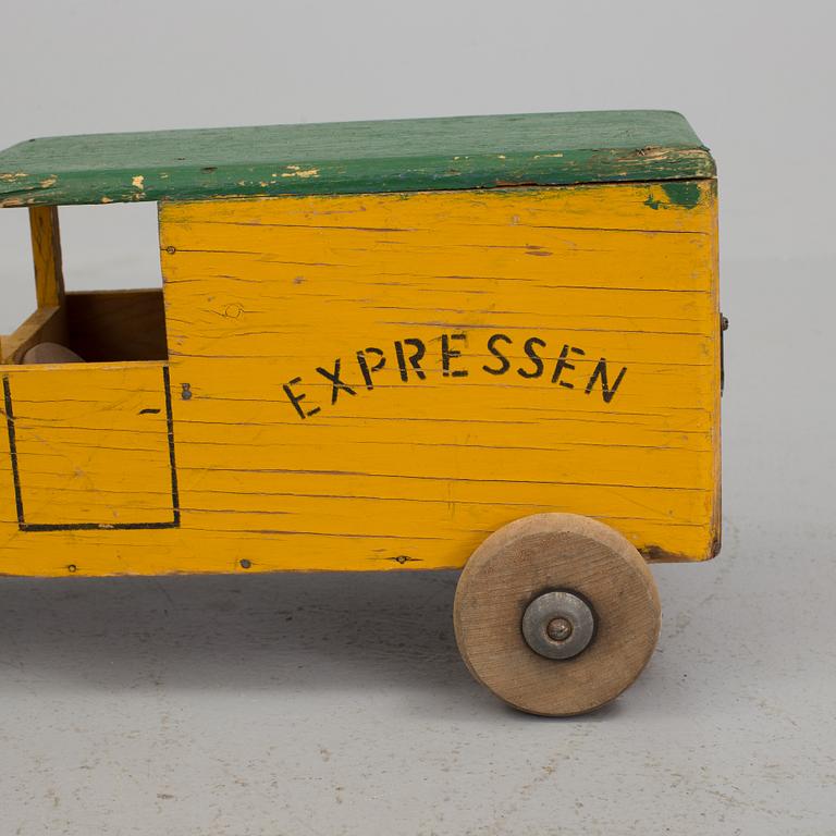 A set of two wooden toy trucks.