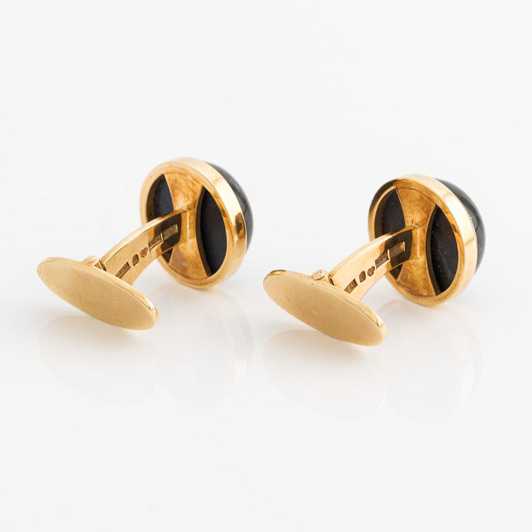 CF Carlman a pair of 18K gold cufflinks with a blue stone, likely spectrolite.