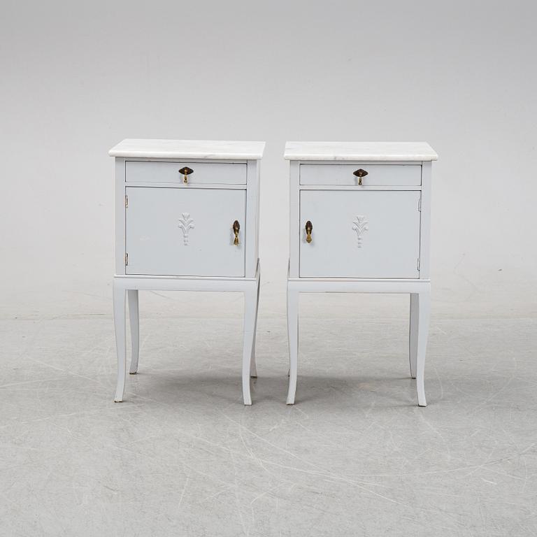 A pair of painted bedside tables with marble tops, 1920's.