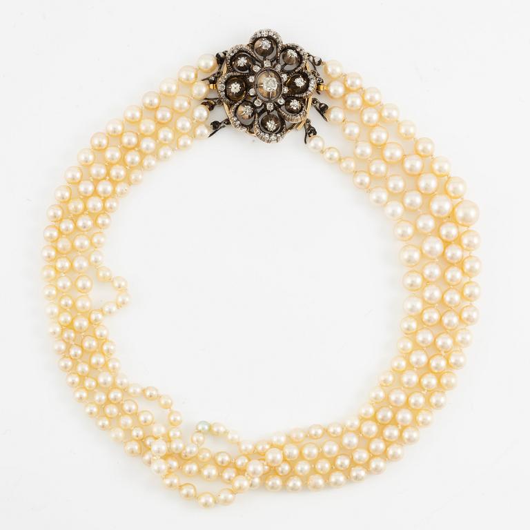 Multi-strand pearl necklace with a clasp/brooch in gold with diamonds,.