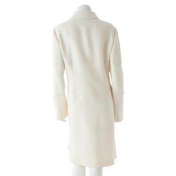 CARACTÈRE, a white wool coat.