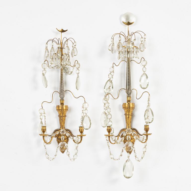 A pair of Gustavian-style ormolu two-light wall candleholders, 19th Century.