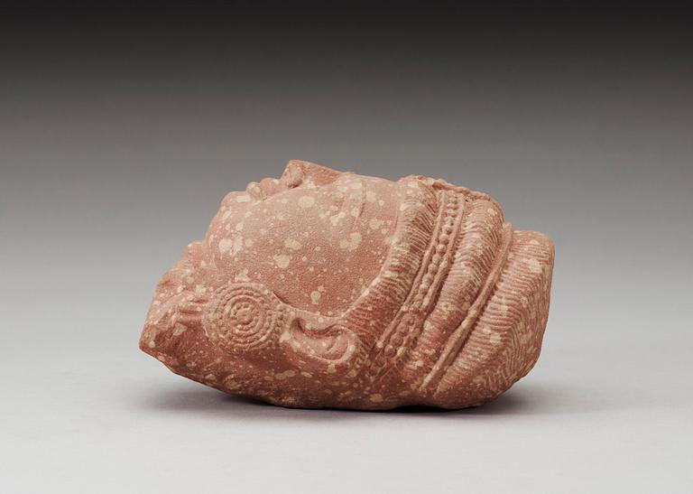 A mottled red sandstone head of Guanyin, Mathura, India, presumably 200-500 AD.