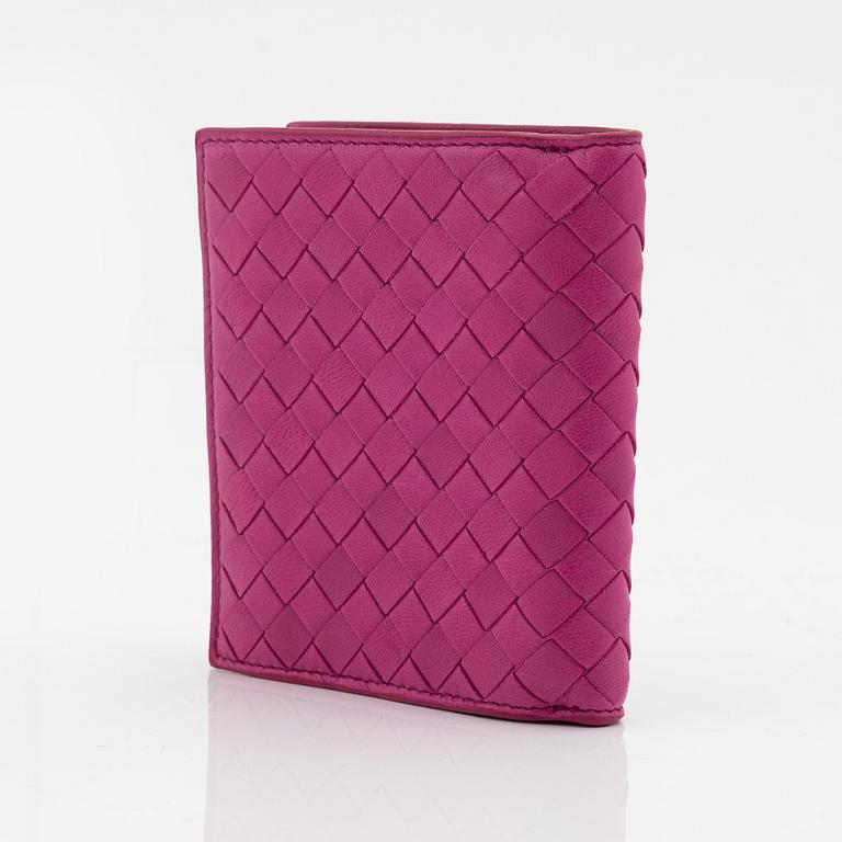 Bottega Veneta, a cerise leather wallet.