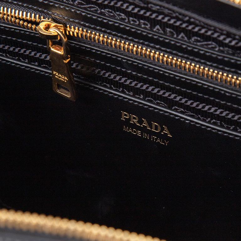 PRADA, a leather bag.