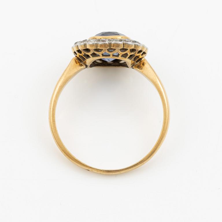 A ring in gold with a cushion-cut purple sapphire and old-cut diamonds, ca first half of the 20th century.