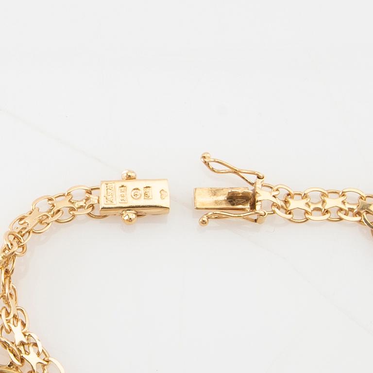 Bracelet 18K gold Bismarck link with charms.