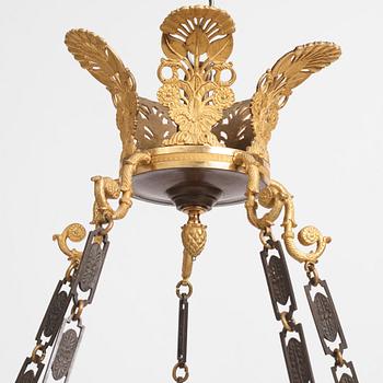 An Empire.style five-branch patinated and gilt bronze chandelier, later part of the 19th century.