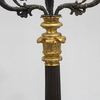 A pair of French Empire-style patinated and gilt bronze five-light candelabra, later part 19th century.