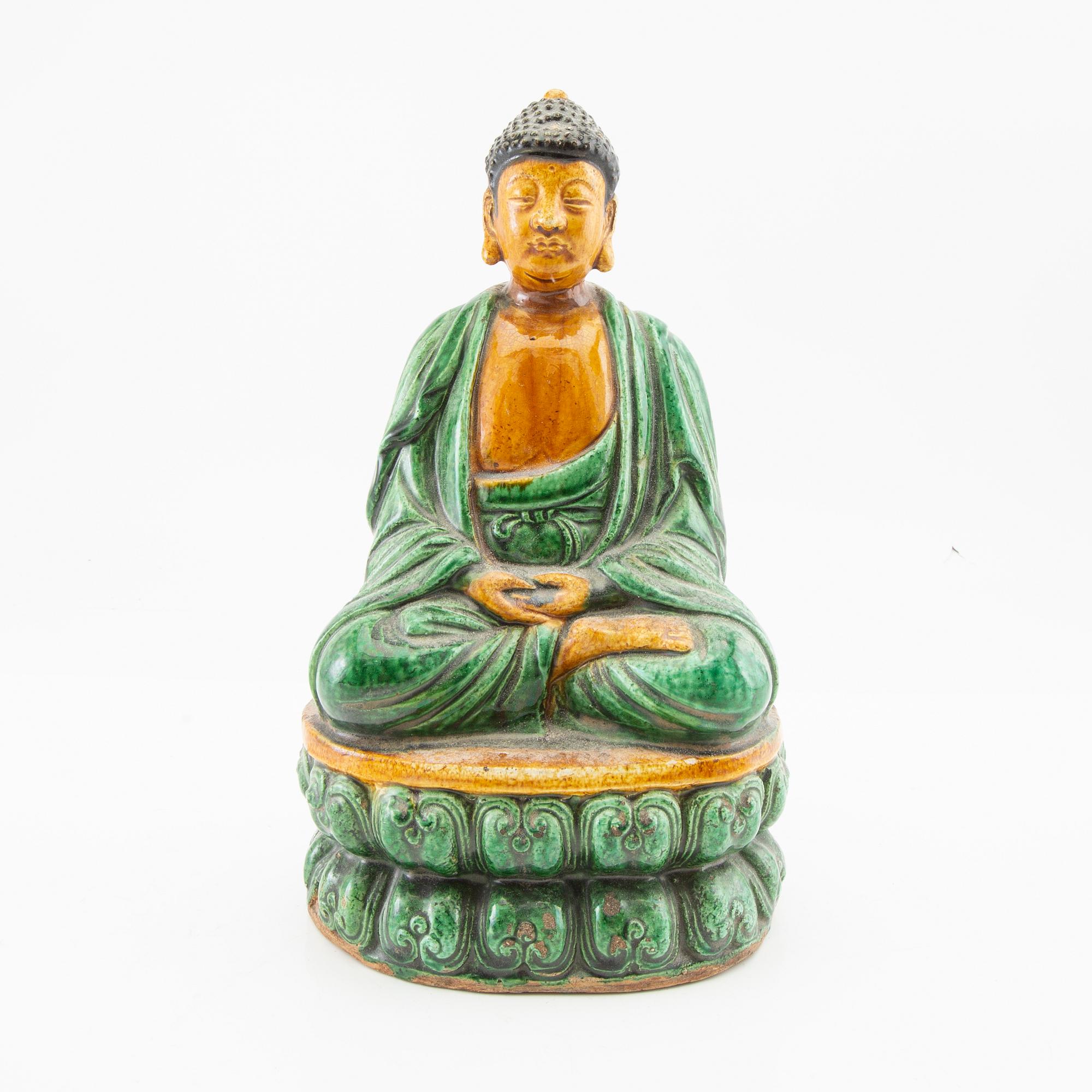 A green and yellow glazed figure of buddha, China, 20th century.